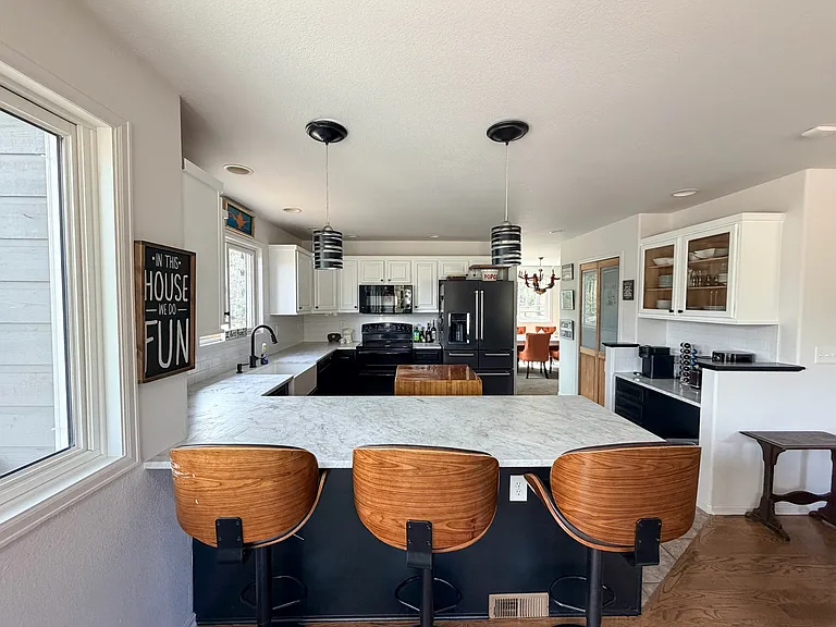 Kitchen area with sitting area, marble counter tops, newer fridge, farm-style sink. Beautiful views!