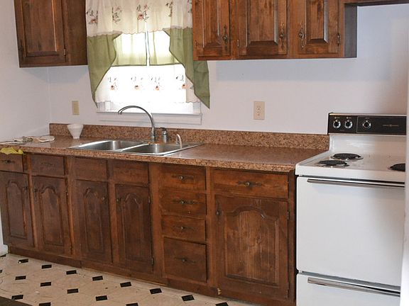 The eat in kitchen has vinyl flooring and wood cabinets.  The appliances will be staying with the home. 
