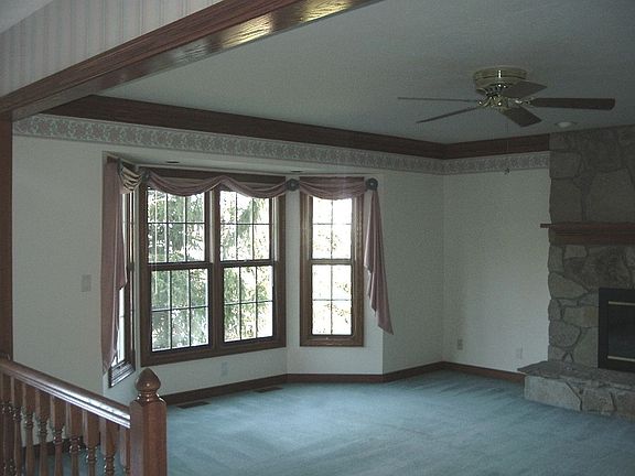 Family room with bow window and stone fireplace