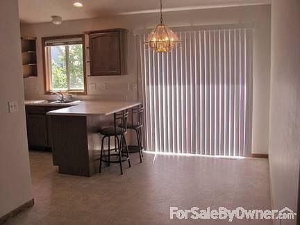 Dining area and breakfast bar
						:
						Vaulted ceiling over kitchen, dining and living room. Great views to backyard.