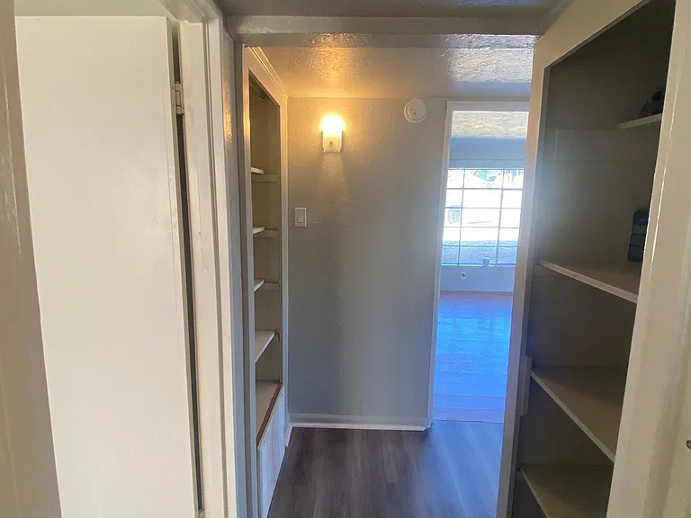 hallway with closets and storage