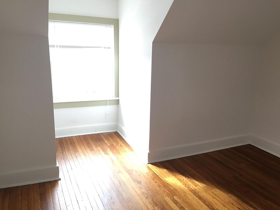 Bedroom with rich wood floors and lots of natural light