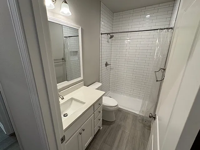Terrace Level Hall bathroom has shower with floor to ceiling ceramic tile and ceramic tile flooring