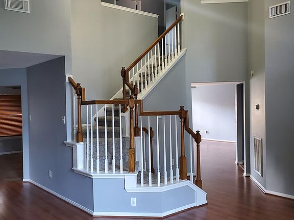 Standing in Living room, looking into Family room to the right and the Kitchen to the left.
