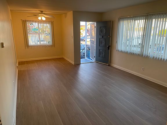 Entry to the Living Room, Living Room with windows looking out to Condon Avenue and Dining Area with fan.