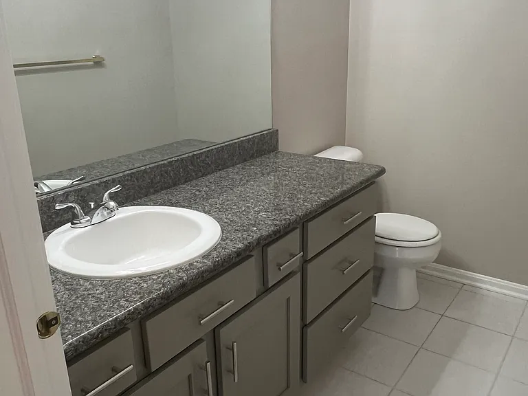 First floor bathroom with new cupboards and granite countertops.