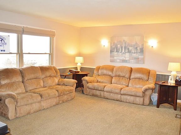 Bright cheery living room.  Window view of farm ground out front. Very nice thermal windows.