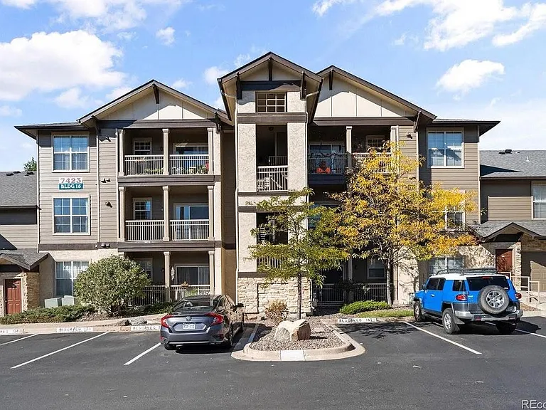 Complex with designated parking spot in front of stairs.