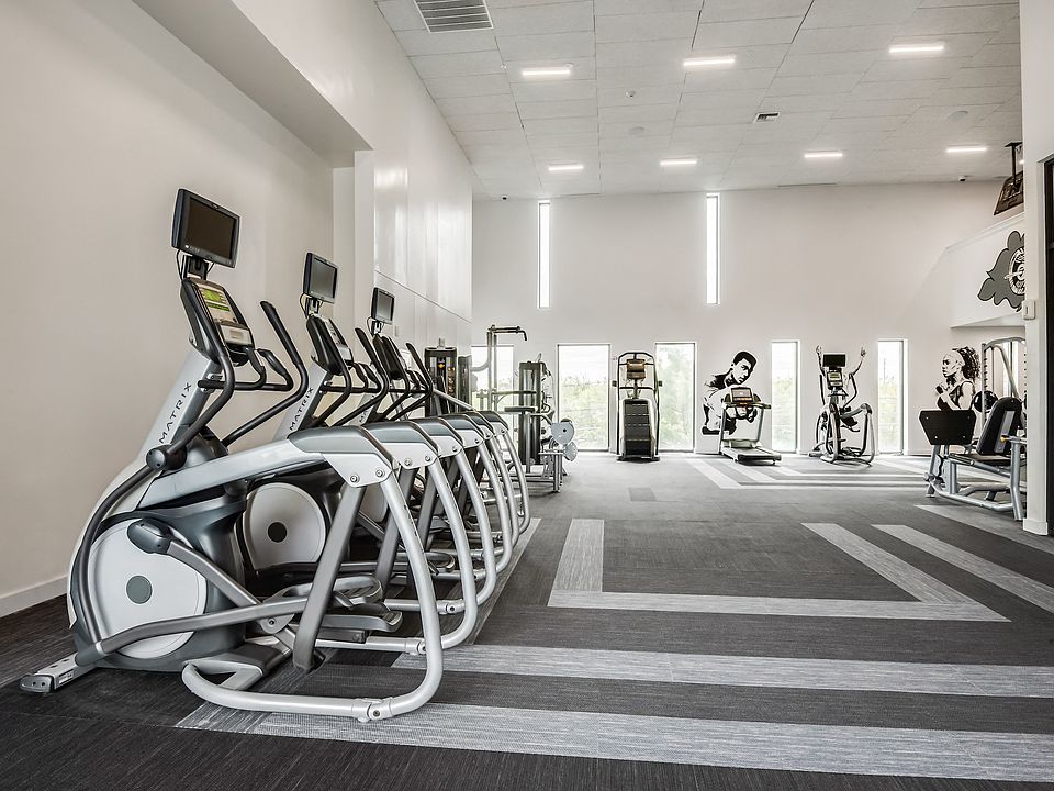 Updated Fitness Center with Cardio Machines and Natural Light