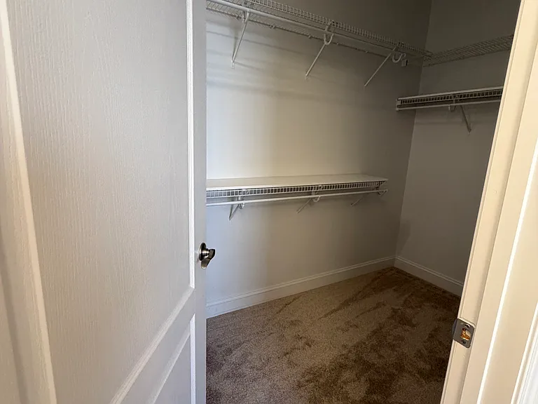 large walk-in primary closet off the primary bathroom