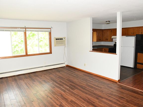 12X20 Living room with pass through to kitchen. Hardwood vinyl flooring.