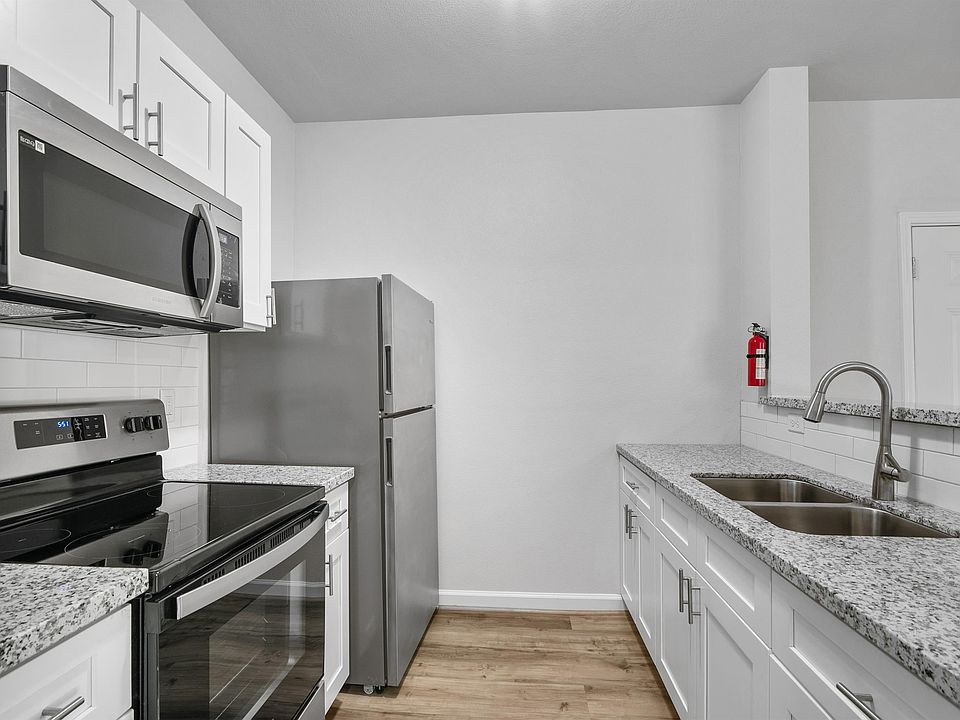 This kitchen features sleek, modern updates with stainless steel appliances