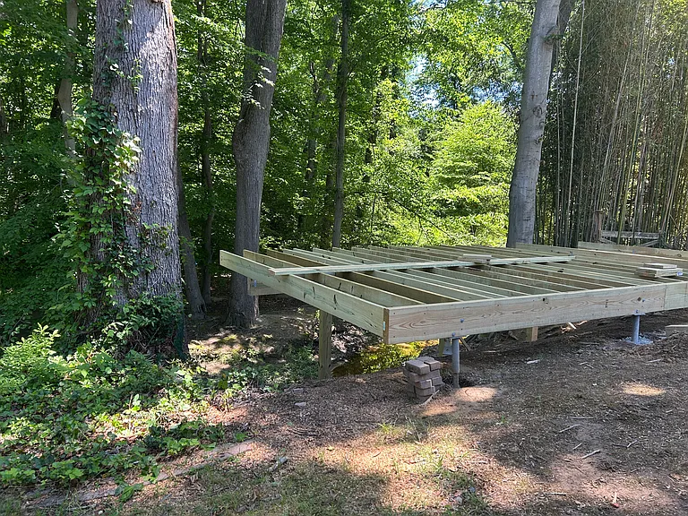 Deck construction ongoing - expected to be finished by mid-June. Overlooks creek.