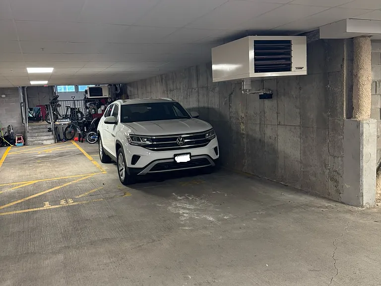 2 car parking spots with storage area behind cars