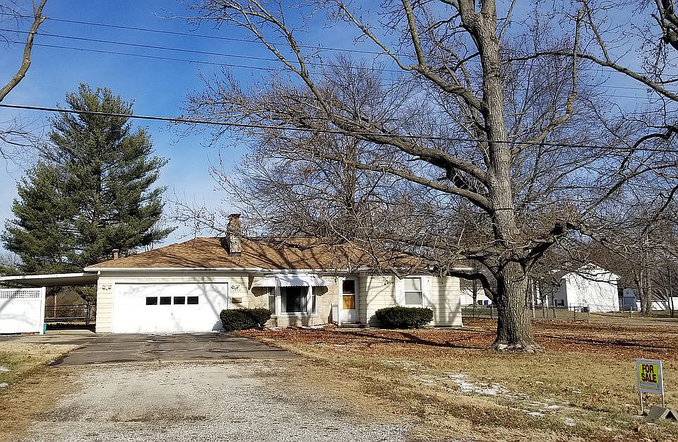 Front of house. Garage and carport