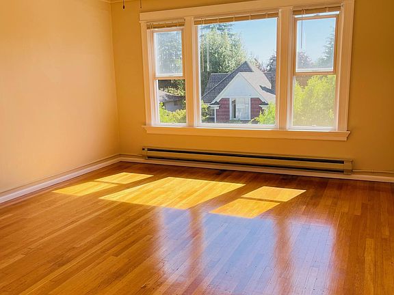 Bright living room with hardwood floors and views to the Cascades!