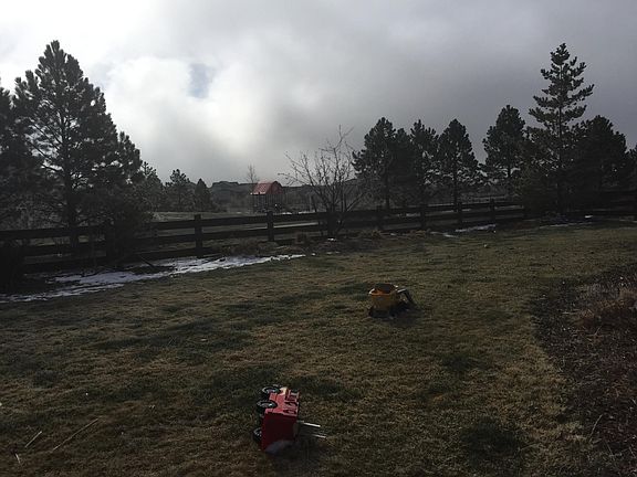 Fenced backyard with view of playground