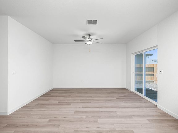 The family room is spacious with a ceiling fan.
