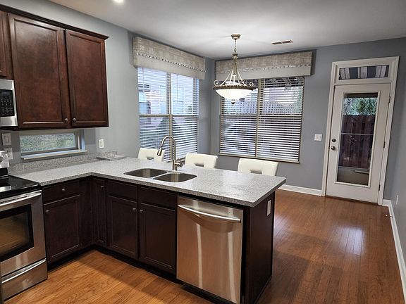 Kitchen with new countertops and stainless steel appliances.