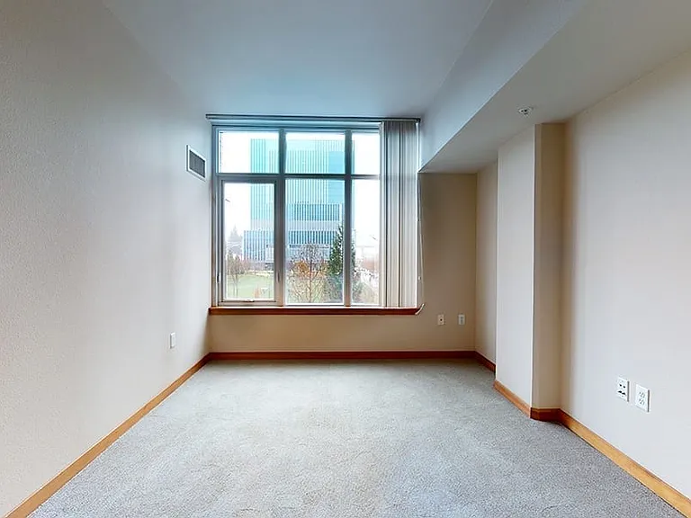 Spacious apartment bedroom with plush carpet flooring