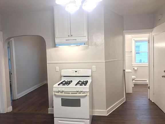 Stove with new stove vent and a chandelier