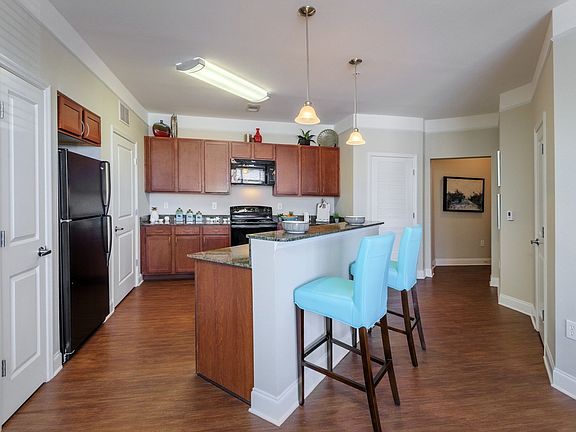 Open Concept Kitchen Featuring Granite Counter Tops