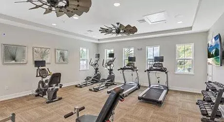 Well-equipped Fitness Center w/ large screen TVs