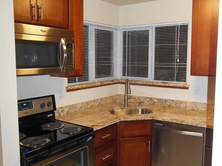 Kitchen with corner sink, and windows