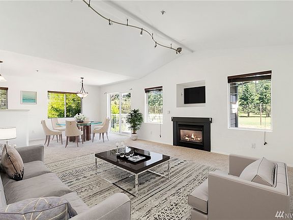 Living room and dining space virtually staged.