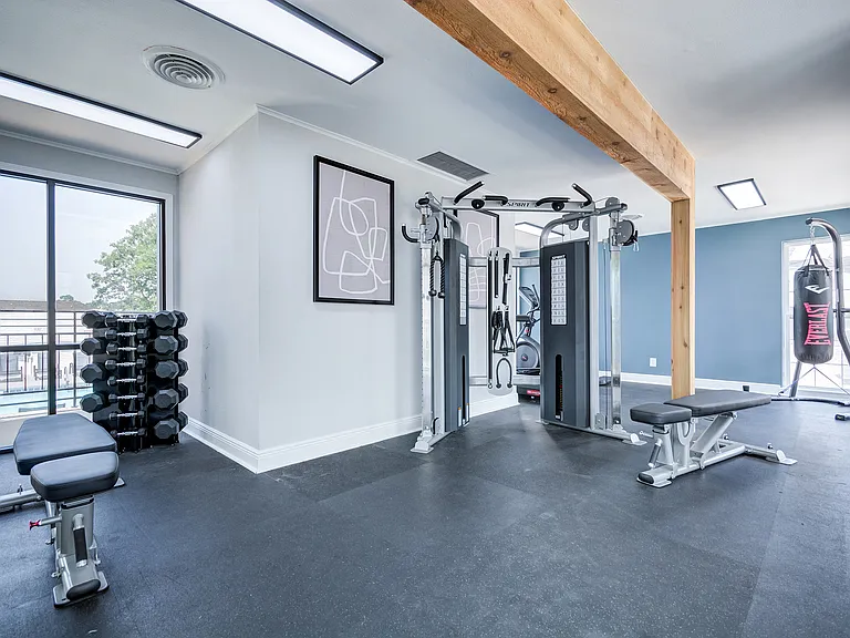 Free weights and a multi-purpose weight machine is shown in the fitness center at ReNew on Cantrell.