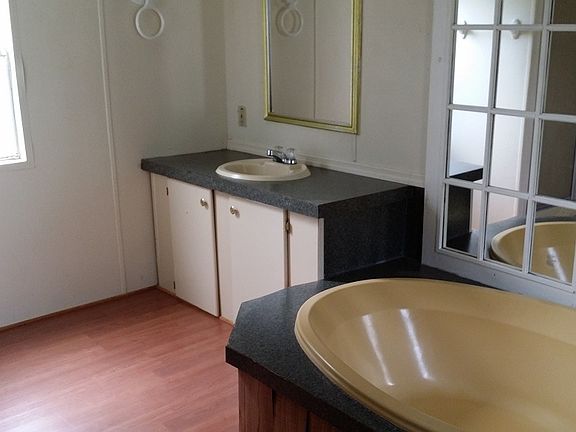 master bathroom has 2 sinks, tub, and shower