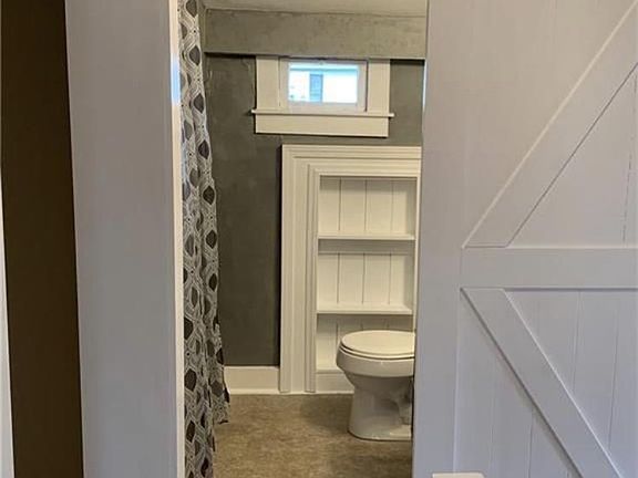 Barn door view into a full bath.