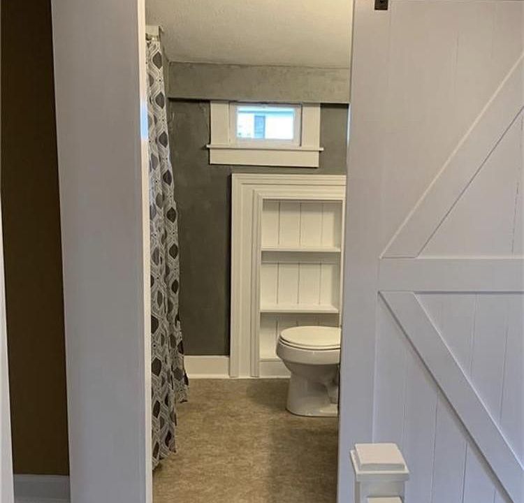 Barn door view into full bath.