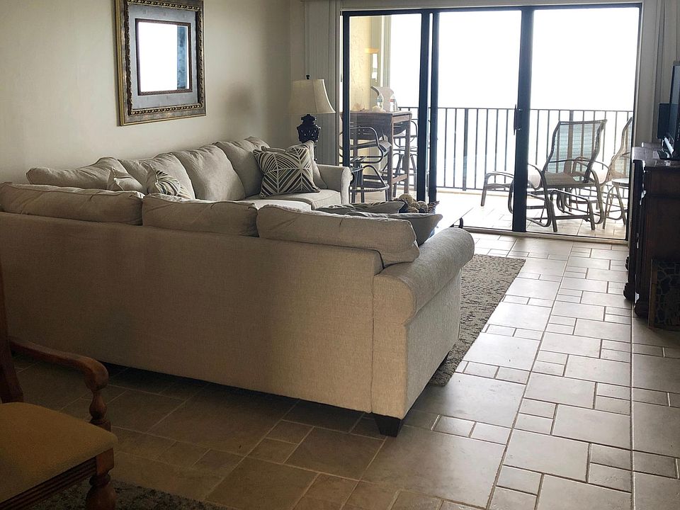Living area; new couch, gorgeous ocean views and balcony showing high top table and chairs great for dining outside and slider chairs with leg rest. So relaxing!
