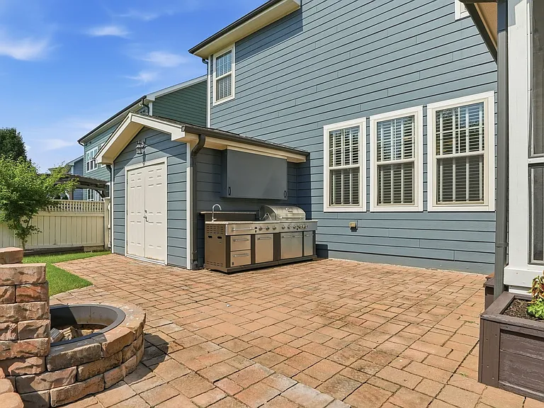 Outdoor kitchen and TV area with Wood fireplace