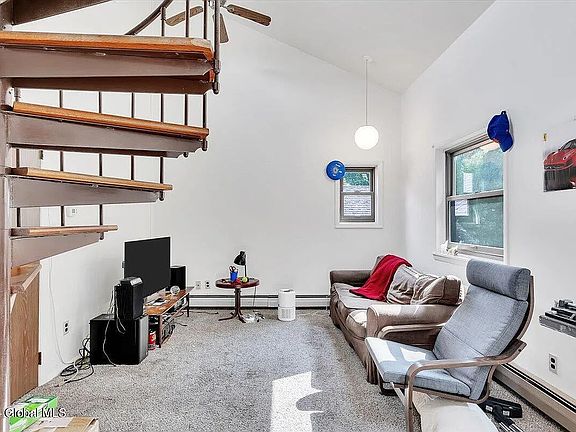 living area, and staircase leading to 2nd floor landing