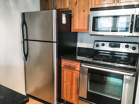 Kitchen with granite counter tops, stainless steel appliances (including dishwasher), and lots of storage not visible in photo