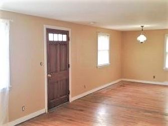Front entry, as shown unfurnished, genuine hardwood floors, sunny rooms. All ceilings and all walls throughout the house have just been repainted.
