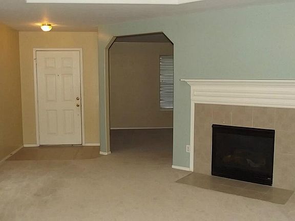 family room with fireplace showing front door & entrance to the study