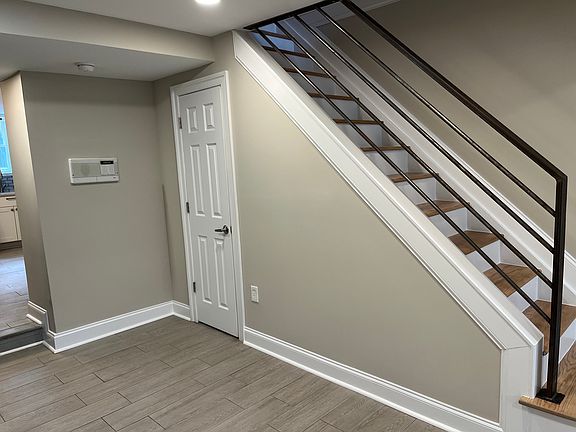 Half bath door & Stairs from view of living room