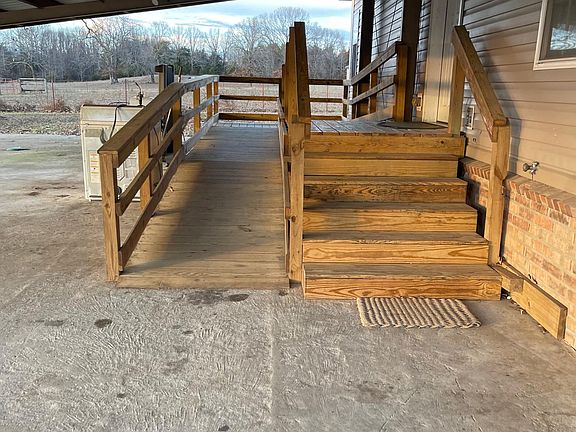 Wheelchair ramp and stairs into house back entrance