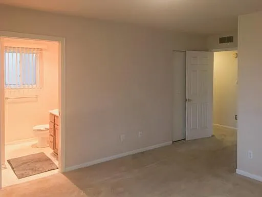 6310-Master Bedroom, View towards MasterBath and hallway, folding door behind door to hallway has additional coat closet