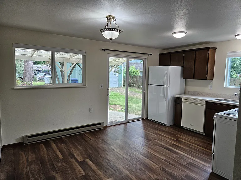 Main floor kitchen showing refrigerator, dishwasher and stove.