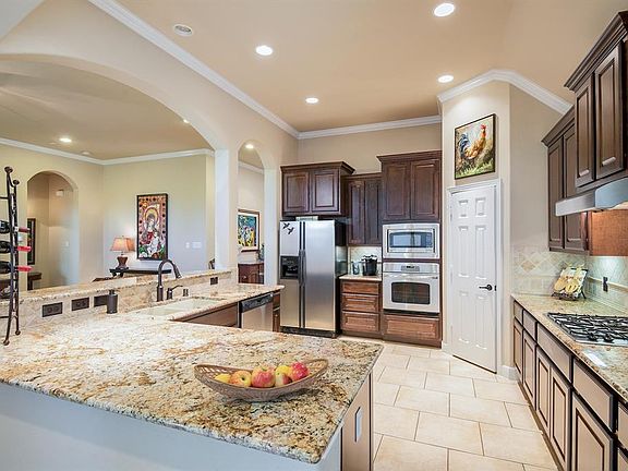 Spacious Kitchen with Great Counter and Cabinet Space. Stainless Steel Appliances, Gas Cook Top, Custom Tile Backsplash, and a Large Pantry Make This Kitchen Stand Out. The Additional Counter Seating Would Make a Nice Breakfast Bar.