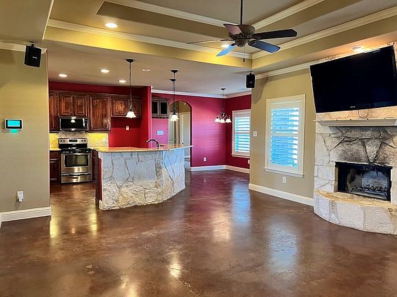 The open floor plan of this house is ideal for entertaining. The kitchen opens up to the living room, which makes it easy to move from one room to the other. The kitchen is spacious and well-appointed, and the living room is comfortable and inviting. The