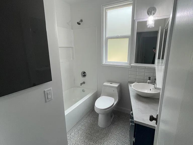 Completely remodeled bathroom with new, tub, tile, floor, & toilet