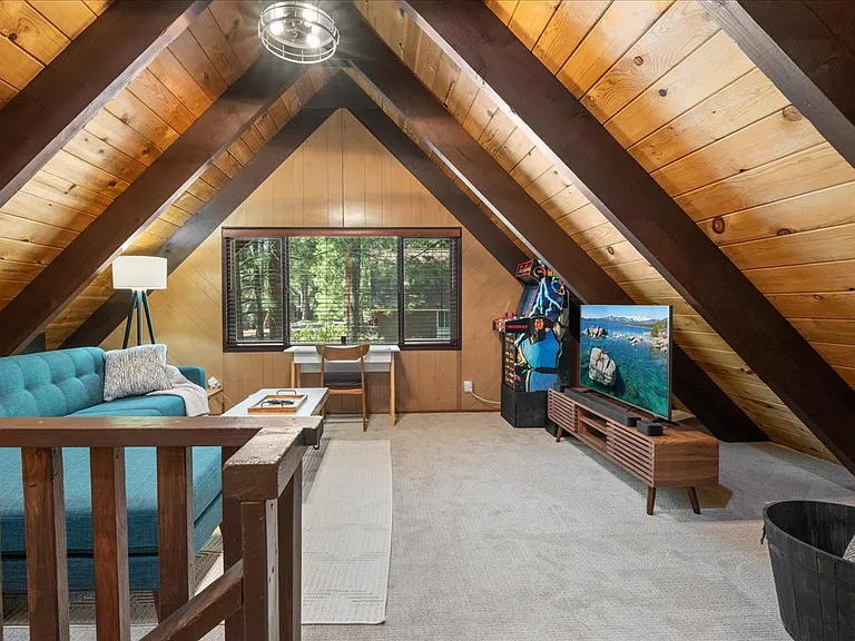 Large open loft with vaulted ceilings, 50" Smart TV, 12-1 arcade cabinet, 86" chofa, ceiling fan, & desk setup for remote work. 300 mb/s WiFi to support all your devices.