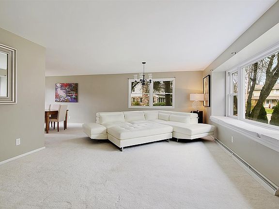 Formal living room with window seat is bright and spacious.