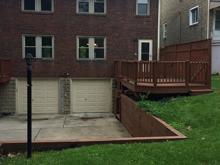 Backyard, driveway, and back deck (left side)
