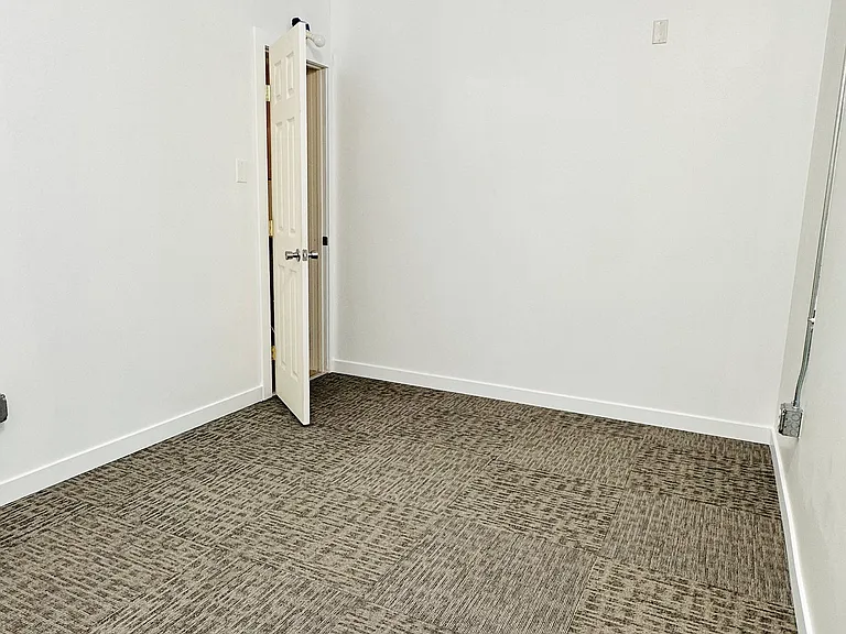 Storage/studio/den room with brand new carpet.